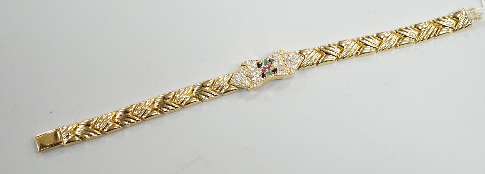 A modern 585 yellow metal, ruby, sapphire, emerald and diamond cluster set bracelet, 17.5cm, gross weight 18.9 grams.